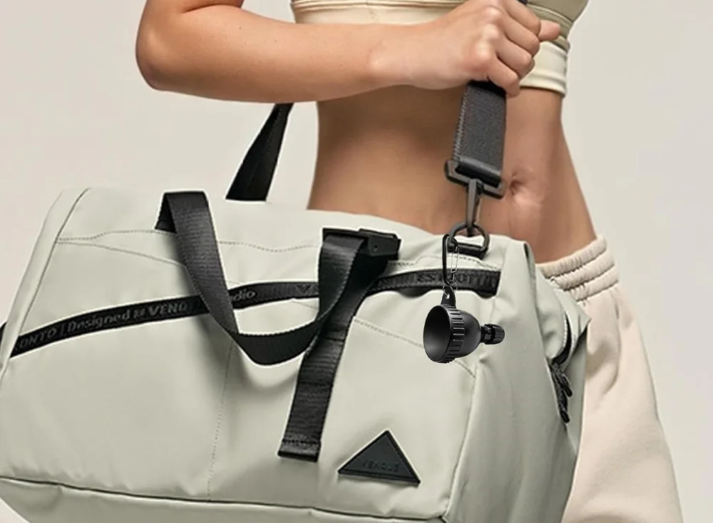 Powder container clipped to a gym bag in the supplied scene